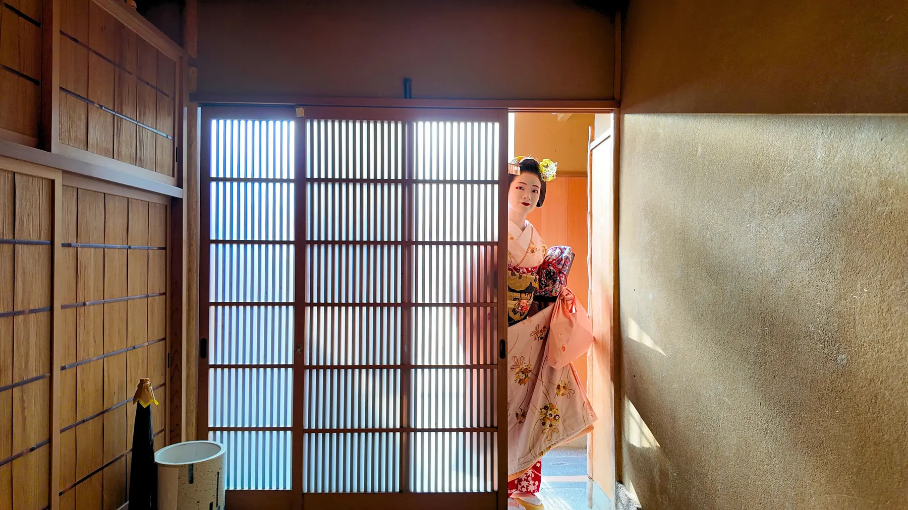 A Maiko at the entrance of a traditional Kyoto house